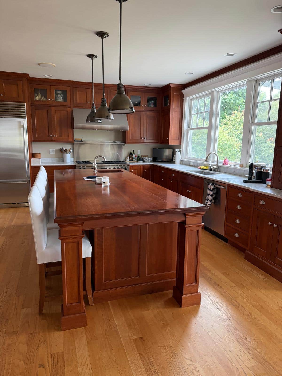 A cherry kitchen with a large island after a full deep cleaning