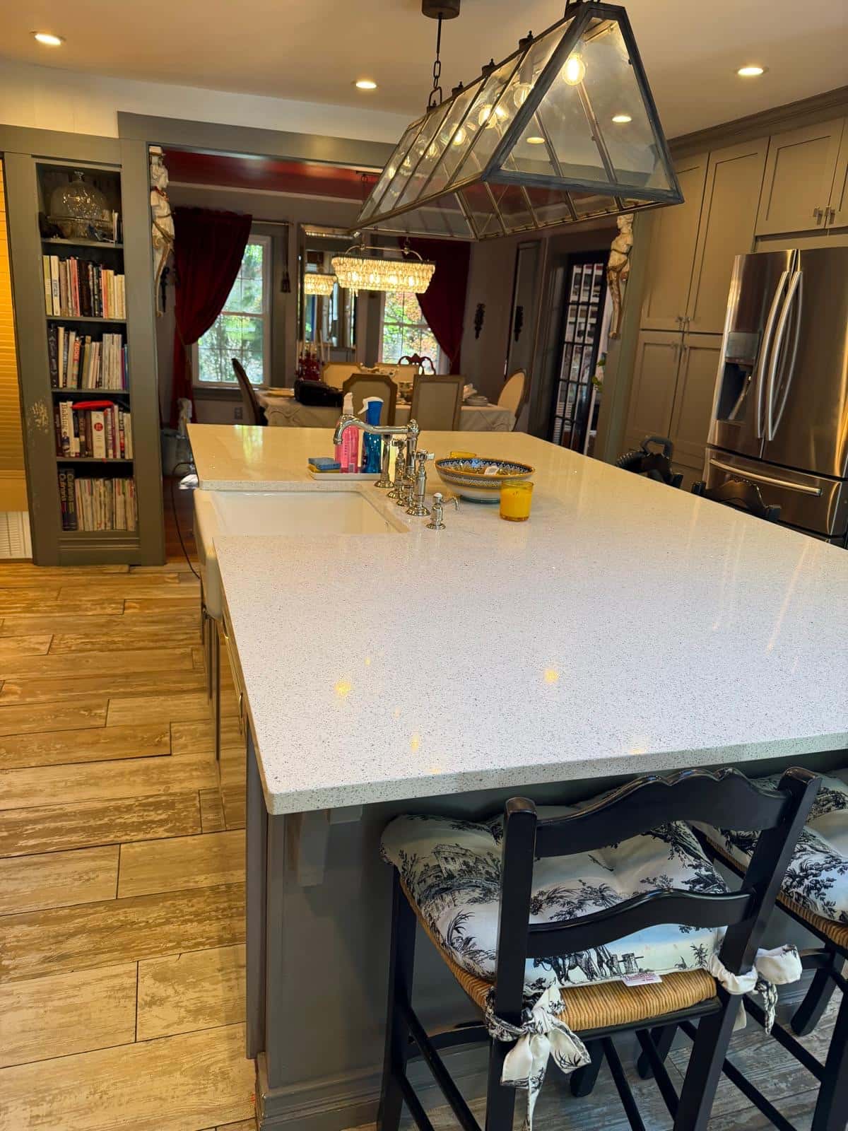 Large quartz kitchen island with farmhouse sink after cleaning
